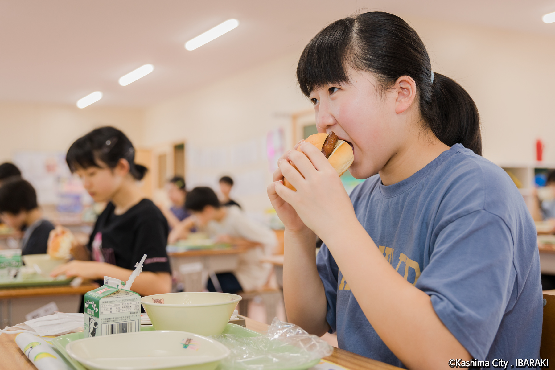 チーズバーガーを食べる児童