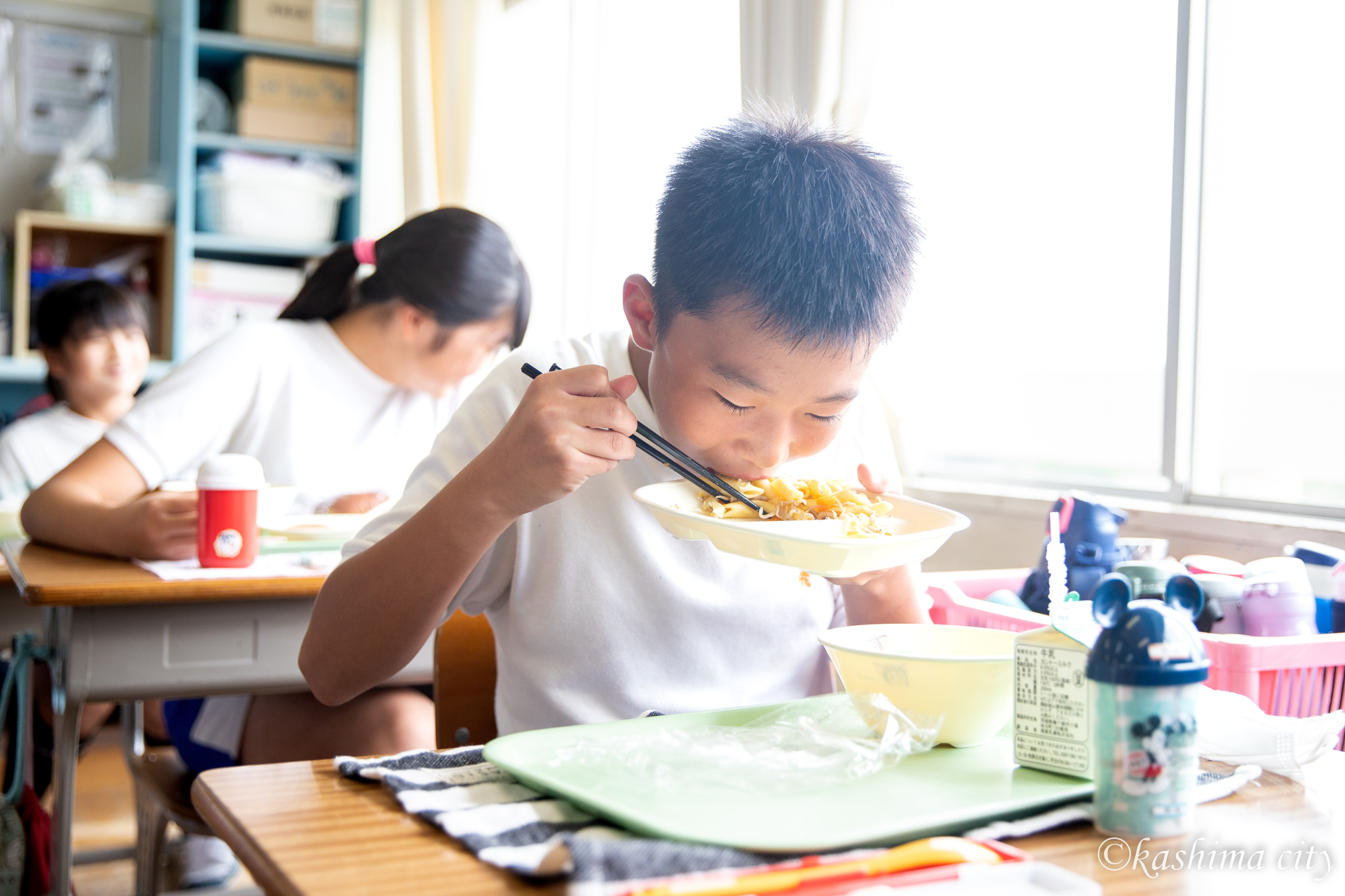 鹿島灘産しらす入りの給食を元気よく頬張る児童